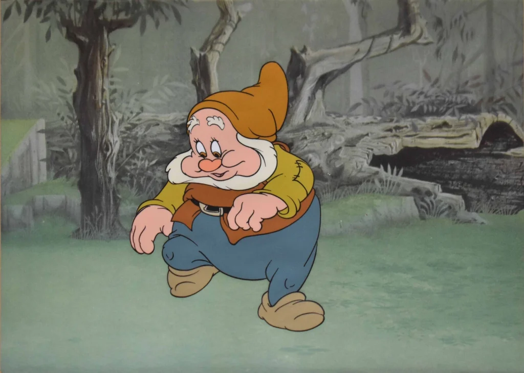 personnage barbu et dessiné qui marche dans un décors de forêt.